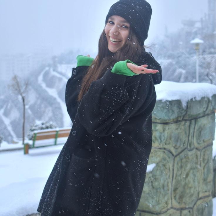 Kaveri Mehta, Lead Design Curator at Pebble Harbor Zen, reviewing corporate floral arrangements